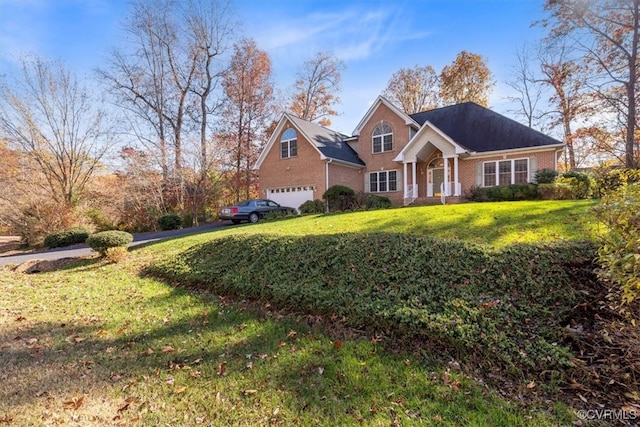 view of front of property with a front yard and a garage