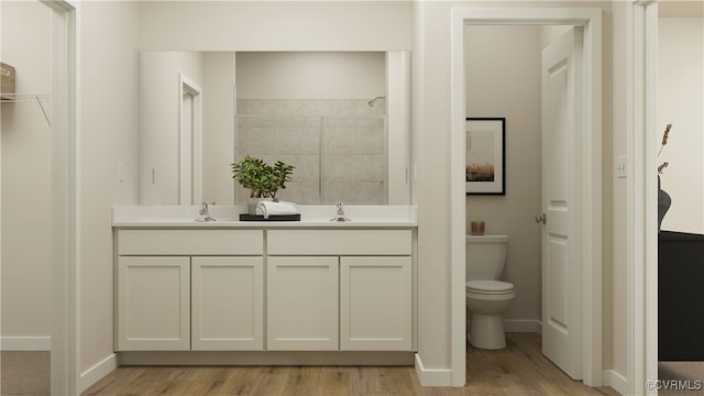 bathroom featuring hardwood / wood-style flooring, vanity, and toilet