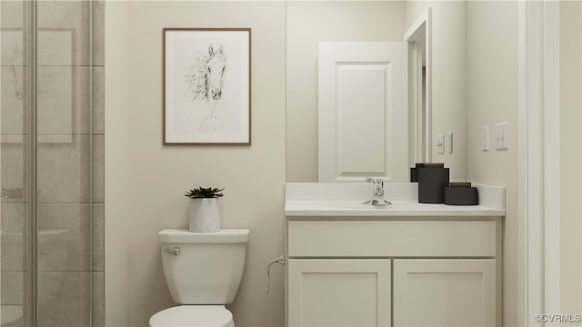 bathroom featuring vanity, toilet, and a shower with shower door