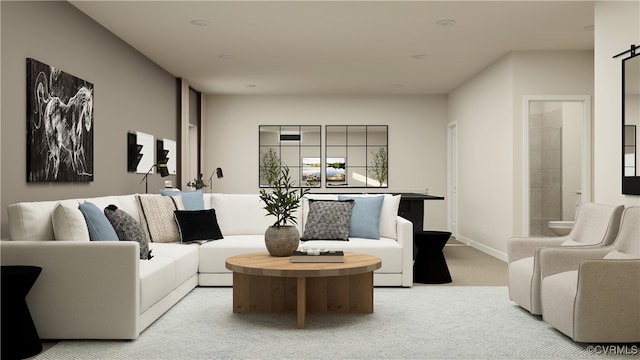 living room with a barn door and light carpet