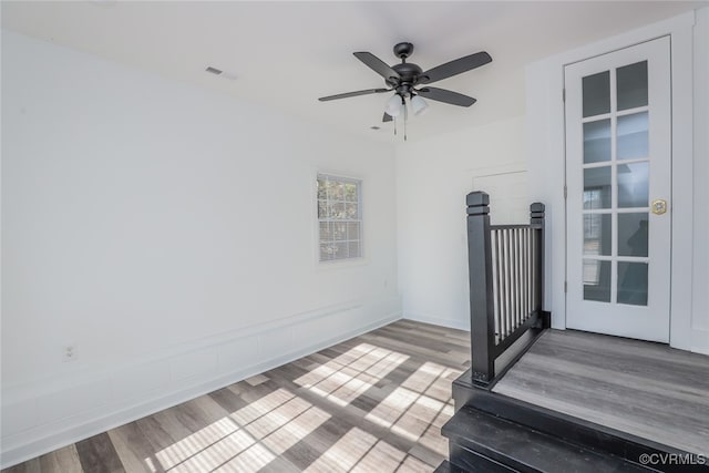 interior space with ceiling fan