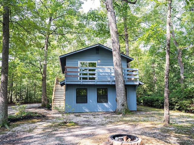 view of property exterior featuring a fire pit and a deck