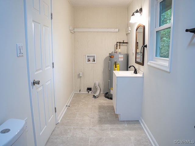 laundry room featuring washer hookup, sink, and water heater