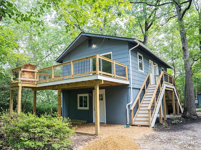 rear view of house featuring a wooden deck