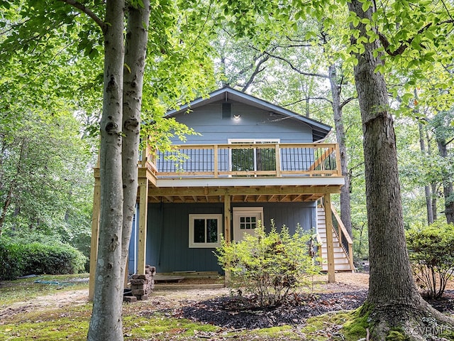 rear view of house featuring a wooden deck