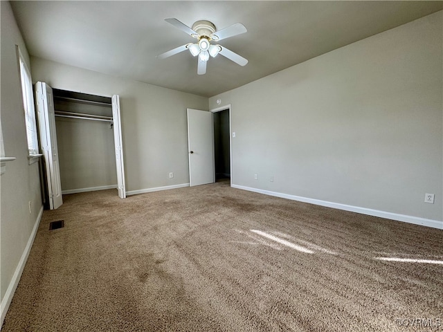 unfurnished bedroom with ceiling fan, a closet, and carpet floors