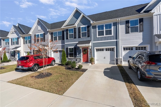 view of property featuring a front yard and a garage