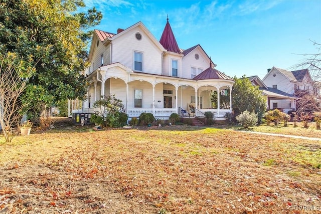 victorian-style house with covered porch and a front yard