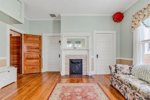 living room featuring crown molding and wood-type flooring