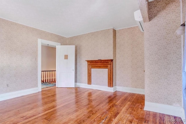 empty room featuring ornamental molding and hardwood / wood-style floors