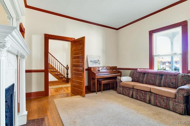 living room with hardwood / wood-style flooring and crown molding