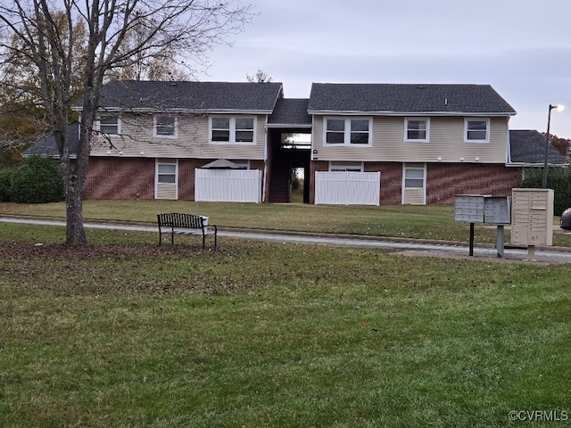 view of community featuring a mail area and a lawn