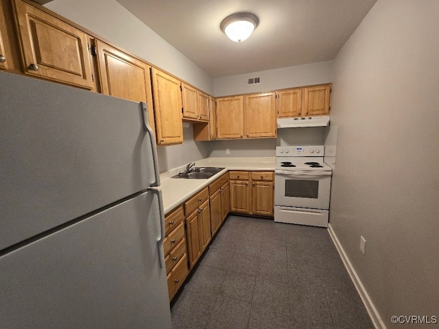 kitchen featuring white electric range oven, stainless steel refrigerator, and sink