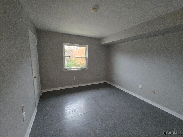 unfurnished room featuring a textured ceiling