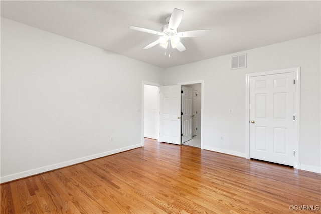 unfurnished bedroom featuring baseboards, visible vents, and light wood finished floors