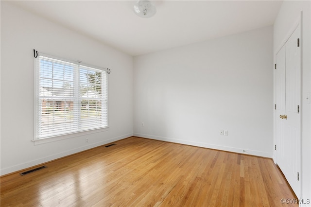 unfurnished bedroom featuring visible vents, baseboards, and light wood-style floors