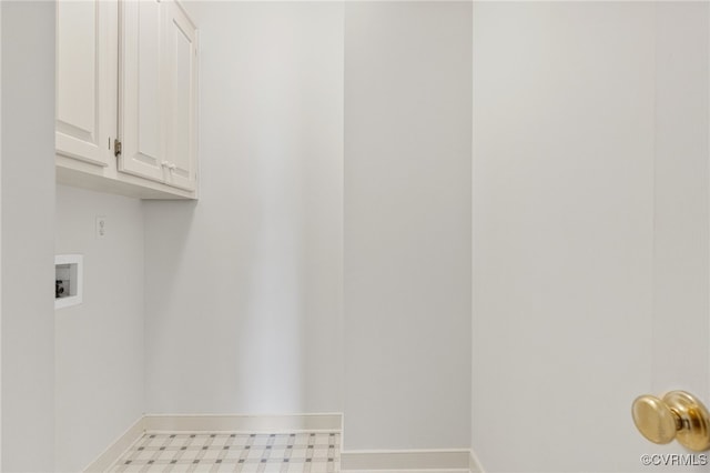 washroom with hookup for a washing machine, cabinet space, baseboards, and tile patterned floors