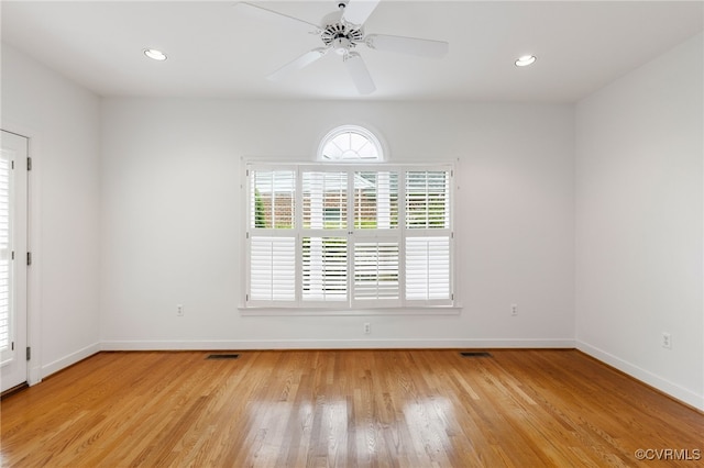 empty room featuring visible vents, baseboards, recessed lighting, ceiling fan, and light wood-style floors