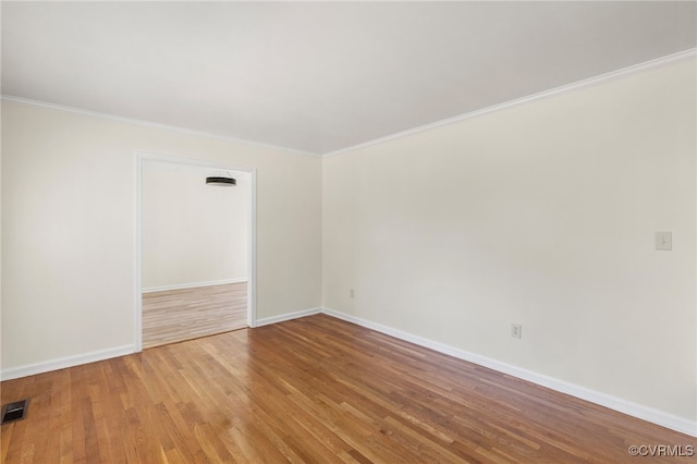 unfurnished room featuring light hardwood / wood-style floors and crown molding