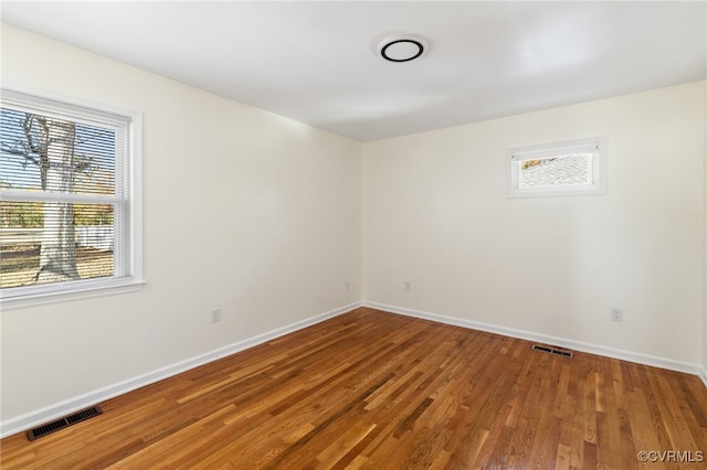 unfurnished room with wood-type flooring