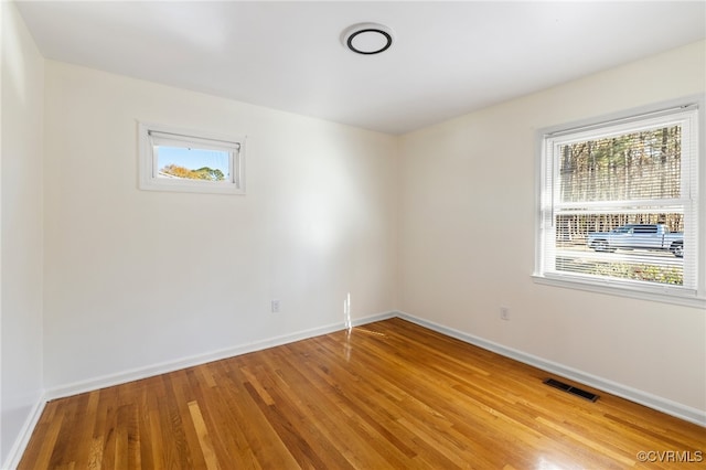 spare room with light hardwood / wood-style flooring