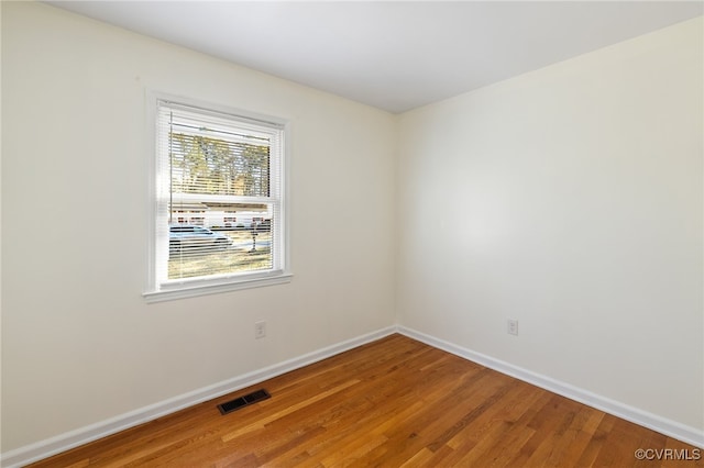 unfurnished room with hardwood / wood-style floors