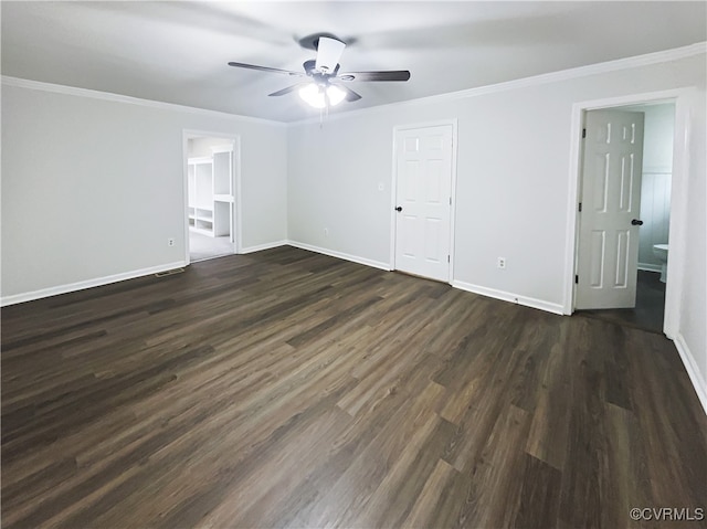 unfurnished bedroom with ornamental molding, ceiling fan, dark wood-type flooring, connected bathroom, and a closet