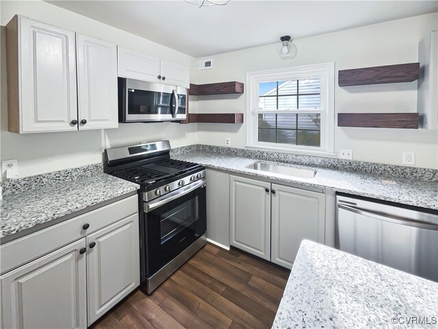 kitchen featuring white cabinetry, stainless steel appliances, and dark wood-type flooring