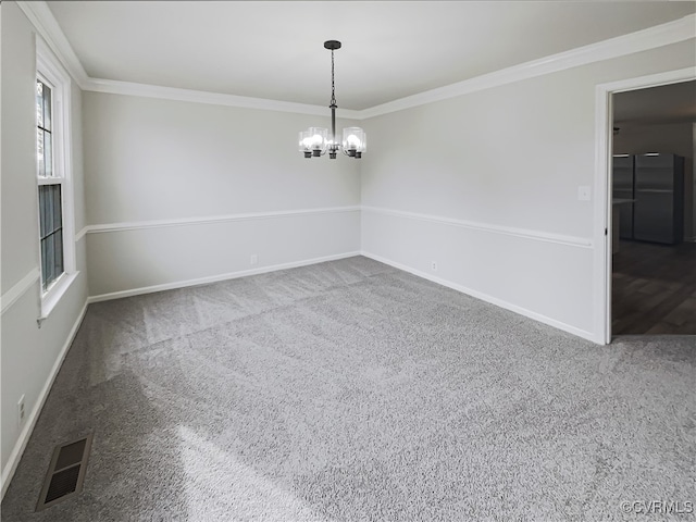carpeted empty room featuring a notable chandelier and crown molding
