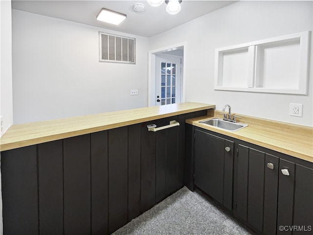 kitchen featuring sink and wood counters