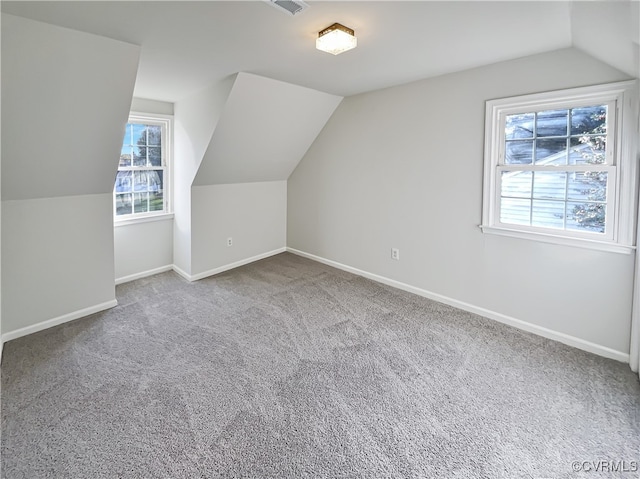 bonus room featuring carpet flooring and lofted ceiling