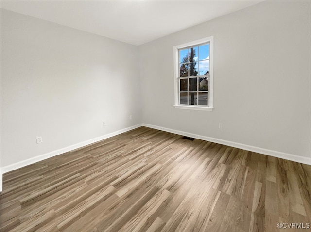 spare room with hardwood / wood-style floors