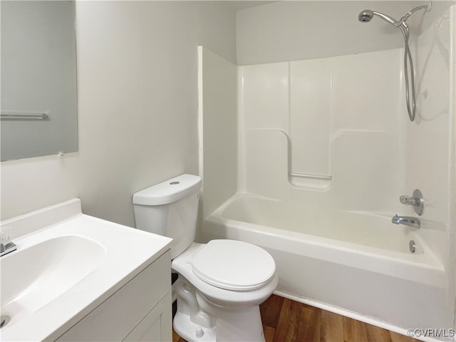 full bathroom featuring vanity, wood-type flooring,  shower combination, and toilet