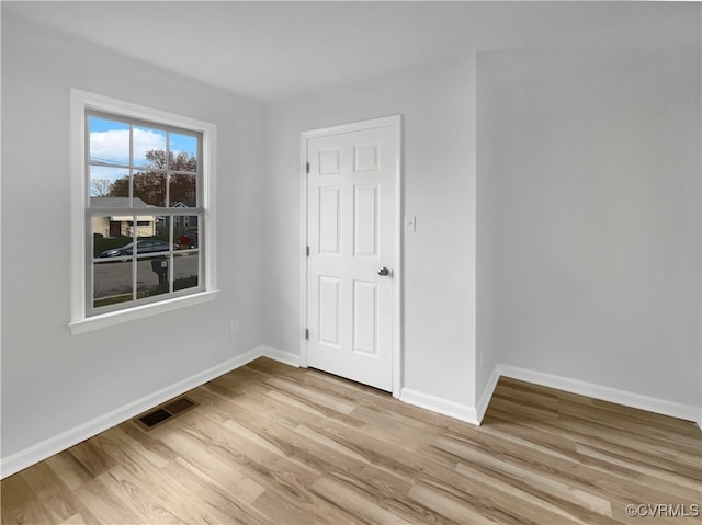 spare room with light hardwood / wood-style floors