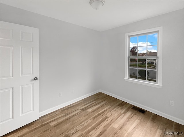 empty room with hardwood / wood-style floors