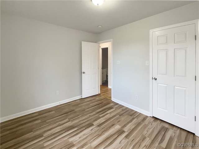 unfurnished bedroom with hardwood / wood-style floors