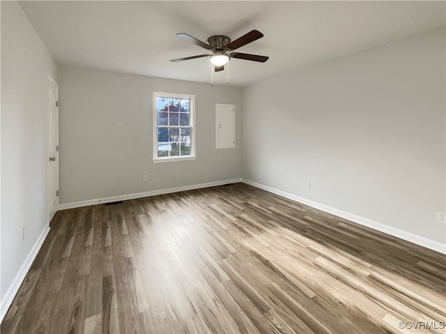 empty room with ceiling fan and wood-type flooring