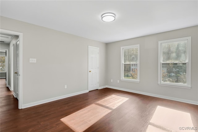 spare room with dark hardwood / wood-style floors