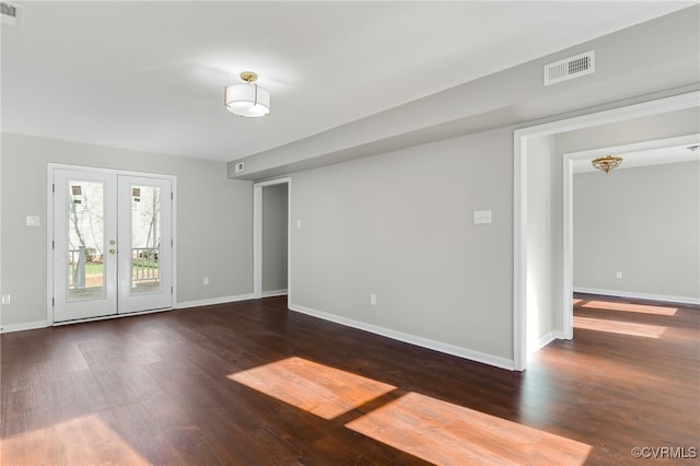 empty room with french doors and dark hardwood / wood-style floors