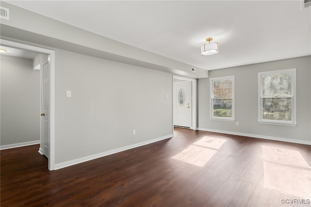 unfurnished room featuring dark wood-type flooring