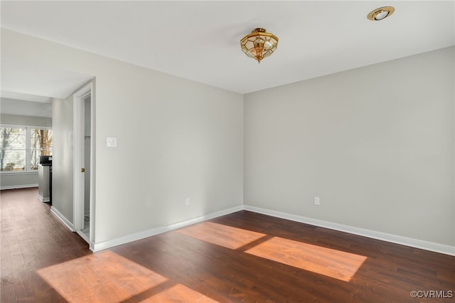 spare room featuring dark hardwood / wood-style flooring