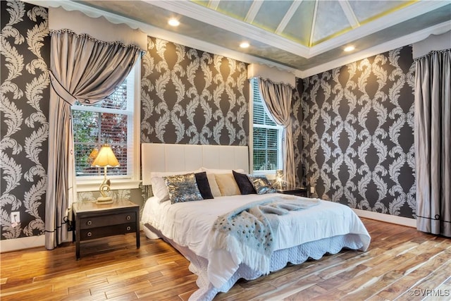 bedroom featuring hardwood / wood-style floors and ornamental molding