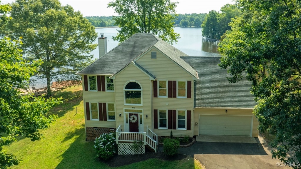 view of front of house with a water view and a front lawn