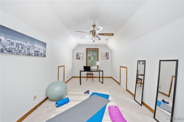 exercise room featuring a textured ceiling, ceiling fan, light carpet, and vaulted ceiling