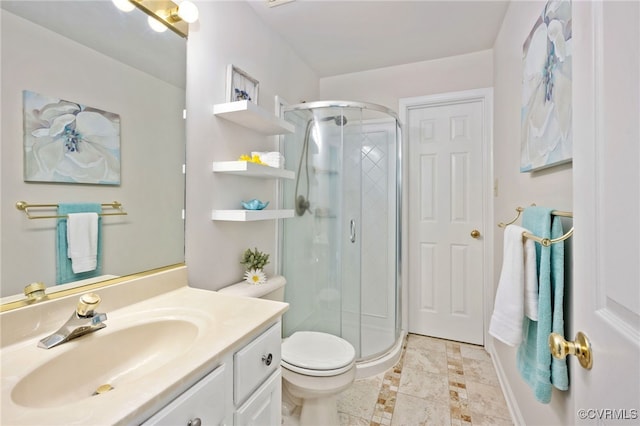 bathroom featuring vanity, a shower with shower door, and toilet