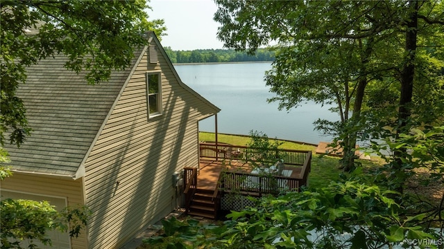 exterior space with a deck with water view