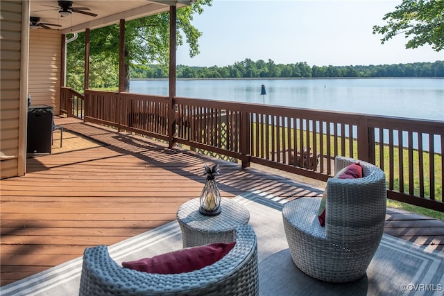 deck featuring a water view and ceiling fan