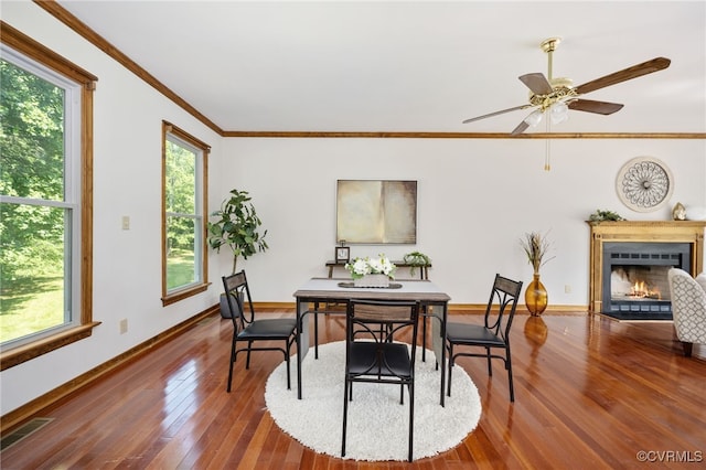 dining area with ceiling fan, hardwood / wood-style floors, and ornamental molding