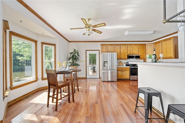 kitchen with crown molding, ceiling fan, stainless steel appliances, and light hardwood / wood-style floors