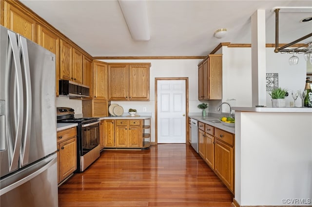 kitchen featuring dark hardwood / wood-style flooring, sink, stainless steel appliances, and ornamental molding